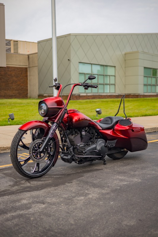 Custom Road King motorcycle in red, side view