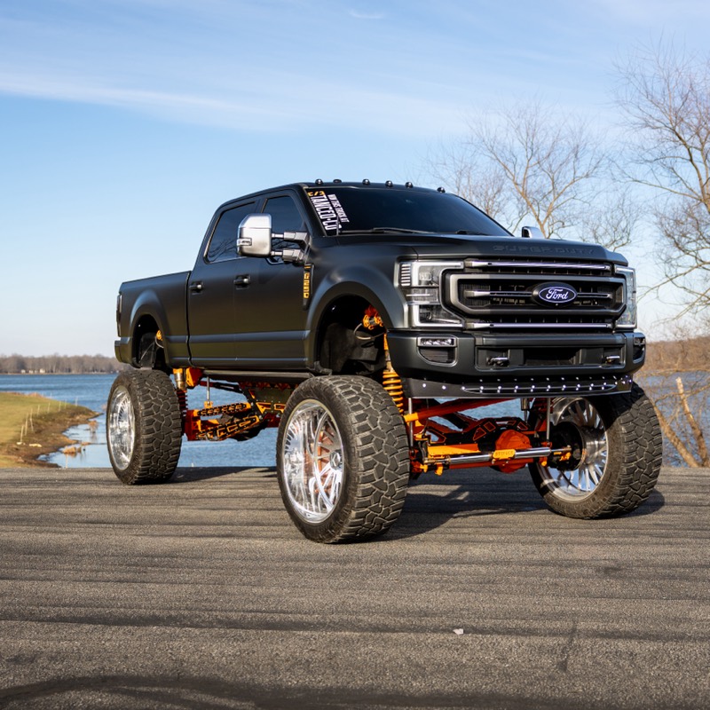 Black lifted Ford F-250 Super Duty Platinum parked by a lake