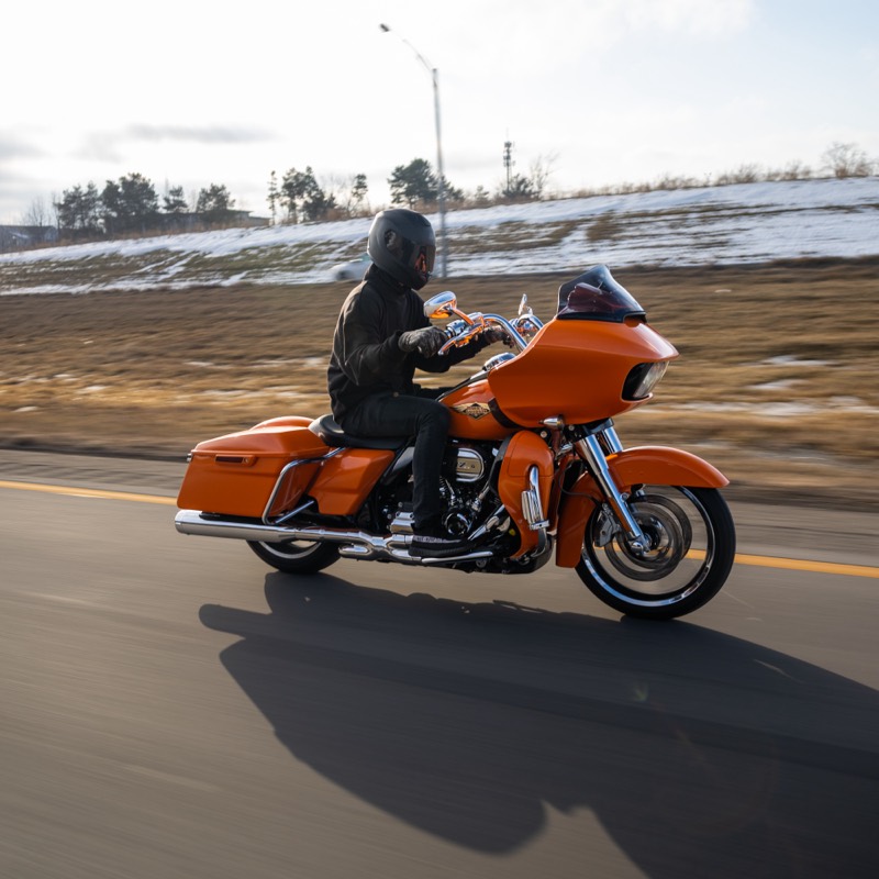 Orange Harley-Davidson CVO Road Glide being ridden on a highway