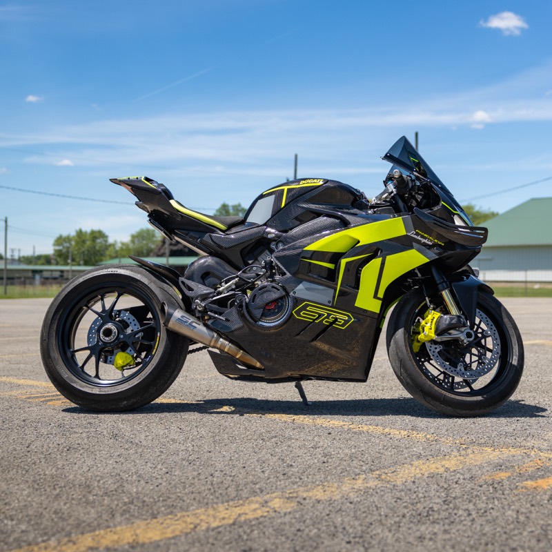 Ducati motorcycle in black with lime green graphics, side view